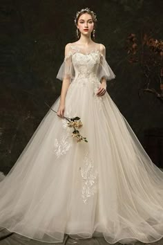 a woman in a white wedding dress holding a bouquet