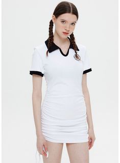 Define your style with the distinctive silhouette of this form-fitting white polo dress. Its smart collar and cuffed sleeves, highlighted by black trimming, offer a nod to the timeless tennis dress, reimagined for the modern woman. The embroidered badge on the chest elevates the piece with a sense of heritage and luxury. Crafted from a comfortable stretch fabric, this dress promises a snug fit that moves with you, making it a staple for those sunny days out or an active afternoon.Style: pullover Fitted White Tennis Dress With Short Sleeves, Classic Summer Tennis Dress, Fitted Polo Dress For Spring, Classic Fitted Tennis Dress For Spring, Classic White Tennis Dress For Spring, Fitted Short Sleeve Polo Dress For Summer, Classic Fitted Tennis Dress For Summer, White Polo Dress For Spring, Fitted Preppy Polo Dress For Summer