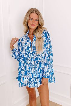 - Add a touch of the tropics to your wardrobe with this chic button-up! With its lightweight material and tropical-themed print, this piece is perfect for a walk down a breezy boardwalk. Whether you're heading to a beachside cafe or enjoying a sunset cruise, this shirt brings a vacay vibe to any occasion. - Unlined semi-sheer lightweight material with an abstract tropical cityscape print - A collared neckline - A button up front - Long sleeves with button closure cuffs - Functional chest pockets Blue Hawaiian Shirt For Beach, Blue Tropical Hawaiian Shirt For Summer, Summer Beach Hawaiian Shirt, Summer Tropical Hawaiian Shirt For Day Out, Tropical Hawaiian Shirt For Summer Day Out, Blue Hawaiian Shirt With Hibiscus Print For Beach, Hawaiian Shirt For Summer Day Out, Trendy Tropical Print Hawaiian Shirt For Vacation, Blue Hawaiian Shirt For Spring