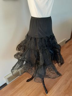 "Vintage Womens Black Nylon Full Circle Petticoat Slip/ Pin Up Rockabilly Half Slip Size M-L Very Good Vintage Condition. No Rips, Tears Or Stains. Elastic Has Probably Lost Some Of It's Stretch. If Replaced Could Fit A Size Small Also. .5\" Elastic Nylon Stretchy Top Section 2 17\" Tiered Stiff Nylon Ruffled Sections Nylon Undercoat Waist 30\"-43\" Hips 50\" Length 26\"" Fitted Petticoat With Attached Cancan For Costume, Fitted Tiered Petticoat For Party, Fitted Tiered Skirt Petticoat For Costume, Fitted Petticoat With Attached Cancan For Dance, Fitted Full Skirt Petticoat For Party, Sheer Fitted Petticoat For Party, Fitted Tulle Petticoat For Costume, Vintage Black Skirt For Costume Party, Costume Petticoat With Attached Cancan