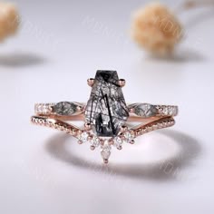 an engagement ring with a black and white diamond