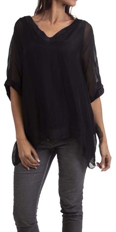 Gentle flowing pure silk, double V-neck silk blouse. Short sleeve finished with wide double-layer hem. Exterior 100% Silk | Interior 95% Viscose, 5% Elastic Model 5'8" One Size Made in Italy Elegant Silk V-neck Tunic, Sheer Black Silk Blouse, Black Sheer Silk Blouse, Elegant Chiffon Tops For Layering, Solid V-neck Blouse For Layering, Black Sheer Silk Tops, Black V-neck Rayon Blouse, Sheer V-neck Blouse For Work, Flowy V-neck Viscose Blouse