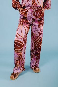 Add some playful flair to your wardrobe with The Tropical Satin Pants. Featuring a vibrant tropical print, these satin pants boast a stylish wide leg cut, perfect for any warm weather occasion. Stand out and make a statement in these quirky and fun pants that are sure to turn heads. Fabric Content: 100% POLYESTER Vacation Rayon Pants With Floral Print, Vacation Floral Print Rayon Pants, Floral Print Rayon Pants For Vacation, Rayon Floral Print Pants For Vacation, Trendy Wide Leg Pants For Vacation, Trendy Vibrant Print Summer Pants, Trendy Summer Pants With Vibrant Print, Vacation Floral Print Wide Leg Rayon Pants, Vacation Floral Print Rayon Wide Leg Pants