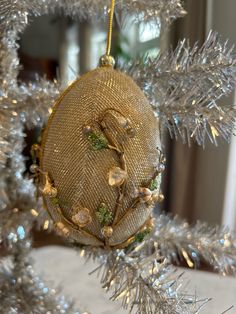 an ornament hanging from the top of a christmas tree