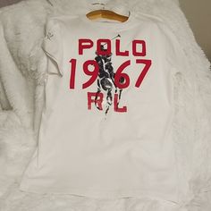 Polo 1967 Rl T-Shirt Ralph Lauren White T-shirt With Graphic Print, Ralph Lauren Cotton Tops With Letter Print, Ralph Lauren Casual Tops With Letter Print, Casual Ralph Lauren Tops With Letter Print, Ralph Lauren Crew Neck Tops With Letter Print, Sporty Ralph Lauren Graphic Print Tops, Sporty Ralph Lauren Tops With Graphic Print, Sporty Ralph Lauren Top With Graphic Print, Sporty Graphic Print Tops By Ralph Lauren