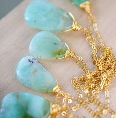 This stunning necklace is handmade with gorgeous specimens of natural Chrysoprase. This gem, also known as green Chalcedony, is said to promote joy and happiness, as well as attract love and prosperity. No two pendants are the same. Some are minty green, while others have flecks of brown, white, or black within them. The chains are sterling silver or 14k gold filled. So go ahead, flaunt your unique style! GEMSTONE: Chrysoprase STONE SIZE: 20 to 32mm (.78 to 1.25") STONE SHAPE: Irregular Smooth P Gold Chrysoprase Pendant Necklace, Chrysoprase Gemstone Beads Necklace For Gift, Prehnite Gemstone Beads Necklace For Gift, Gold Chrysoprase Necklaces As A Gift, Gold Chrysoprase Necklace For Gift, Handmade Chrysoprase Necklaces In Nature Style, Green Prehnite Necklace For Gift, Chrysoprase Emerald Necklace For Gift, Handmade Green Chalcedony Necklaces