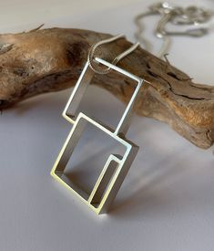 "Double square geometric pendant, on an 18\" snake chain. Sterling Silver Contemporary Statement Geometric Pendant. Handmade in the UK. This stunning, elegant, simple sterling silver pendant will suit all outfits and occasions. It can be worn in various ways. A beautiful gift to be treasured. This pendant is handmade silver tubing. It measures overall 36mm x 25mm x 4mm deep. It is set on an 18\" snake chain made from 100% recycled silver. This pendant is part of a new sterling silver range of jewellery designed and made by Coelo. It will arrive in a black presentation box, with a Coelo logo. Coelo design and hand craft contemporary geometric statement jewellery in high quality sterling silver.   Based in the UK. Coelo:adorn  Know. First Who You Are, Then Adorn Yourself Accordingly." Silver Range, Geometric Jewellery, Diy Jewelry Projects, Geometric Pendant, Geometric Jewelry, Recycled Silver, Jewelry Projects, Snake Chain, Sterling Silber