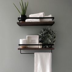 two shelves with towels and plants on them