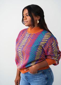 Style#: 7008/P7008 Stand out this fall in the beautiful Niambi crewneck in the vibrant blue and orange Rainbow Trial Lines print. Features: Crew Neck Sweater Hem lands at high hip Contrast colored rib knit at collar, sleeve and waist 45% cotton, 55% acrylic​ Designed in the USA, imported Care Instructions: Hand wash cold. Do not soak. Do not bleach. Lay flat to dry. Models: Size: S | Height 5'7" | Bust 40" | Waist 27 | Hips 41.5" Orange Rainbow, Smart Casual Work, Eye Fashion, African Inspired Clothing, Finding My Style, Braids With Beads, Living My Best Life, Off Shoulder Sweater, Look Good Feel Good