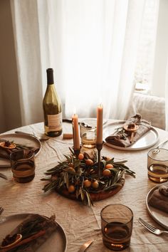 the table is set with candles and plates