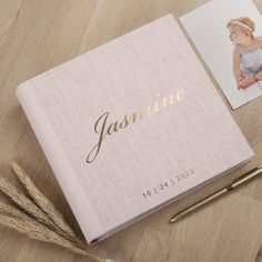 a baby's photo album with the name jasmine written in gold on it