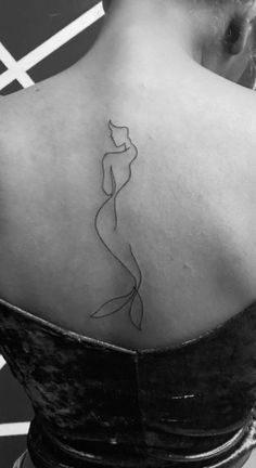 the back of a woman's shoulder with a line drawing on her left arm