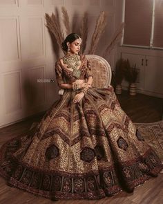 a woman sitting on top of a chair wearing a dress with feathers in her hair