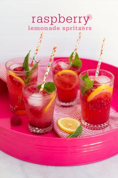 raspberry lemonade spritzers on a pink tray