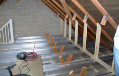 an attic with exposed rafters and tools on the floor