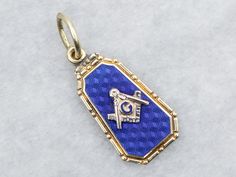 Crafted of beautiful blue guilloche enamel on a background of green gold, this antique Masonic pendant is simply astounding, with the reverse featuring the owner's original initials "T.L.T." in bold font, a perfect historic piece ready to wear or gift! This pendant does not come with the chain shown. Please feel free to contact us, we will help you find the perfect chain for your style and budget! Metal: 14K Green Gold Material: Enamel Monogram: "T.L.T." in Bold FontMeasurements: 12 x 29 mm, wit Blue Engraved Enamel Jewelry, Blue Enamel Engraved Jewelry, Blue Hallmarked Medallion Jewelry, Blue Enamel Locket Jewelry, Blue Engraved Enamel Necklaces, Blue Enamel Engraved Necklace, Blue Engraved Amulet Style Jewelry, Blue Engraved Amulet Jewelry, Blue Engraved Necklace Collectible