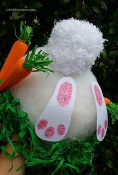 a white stuffed animal with carrots painted on it