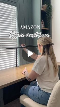 a woman sitting at a desk with the words amazon coffee machine