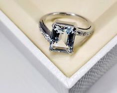 an engagement ring with a square cut diamond