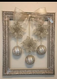 a silver frame with ornaments hanging from it