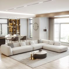 a modern living room with white furniture and large windows in the back ground, along with hardwood flooring