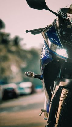 a blue motorcycle parked on the side of a road