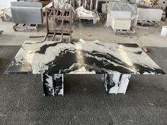 a black and white marble coffee table sitting on top of a gray carpeted floor