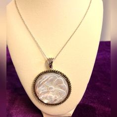 45mm Round Carved White Mother-Of-Pearl Flower And Round Marcasite Rhodium Over Sterling Silver Enhancer With 24" Singapore Chain. Measures Approximately 2.75"L X 2.13"W. 5.5mm Bail. Lobster Clasp With 2"Extender. Finished Back.. New In Box Elegant Round Cabochon Necklaces, Anniversary Mother Of Pearl Jewelry With Pearl Chain, Vintage White High Luster Jewelry, Luxury Pearl White Mother Of Pearl Necklace, Exquisite Silver Pearl Necklace Gift, Exquisite Silver Pearl Necklace For Gifting, Exquisite Silver Pearl Necklace As Gift, Exquisite Silver Pearl Necklace For Gift, Exquisite White Jewelry With Pearl Charm