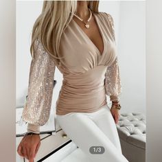 Gift This New Elegant Blouse Or Keep It For Yourself! This Light Sand-Colored Blouse With Contrast Sequin On The Sleeves And A Plunging Neckline Can Be Worn Casually With A Pair Of Jeans Or For Work By Wearing It With A Pencil Skirt & A Camisole Underneath. Pit-To-Pit Is Approx. 18" Sleeve Length Is Approx. 24" Waist Is Approx. 26" Length Is Approx. 25 & 3/4" Bust Is Approx. 33" Material: 97% Polyester/ 3% Spandex (Photo Credit: Chic Me) 2023 Clothing, Belle Silhouette, Autumn 2023, Straight Dress, Outfit Casual, Lantern Sleeves, Middle Age, Synthetic Fiber, V Neck Tops