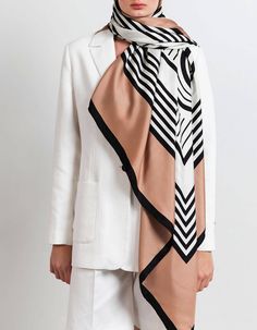 Elegant large silk scarf with Heijne signature logo. The graphic motiv in black and creme contrast beautifully with the warm camel color. Wear it loosely draped over your shoulders with your coat or tie as top or skirt. Our newest scarves are printed on both sides of the fabric. That means that the back side is equally beautiful as the front side.Material and size Material: 100% silk twill Measurements: 135 cm x 135 cm Care instructions low-middle iron hand wash delicate machine wash no bleach d Chic Silk Scarves For Winter, Chic Formal Silk Shawl Scarf, Chic Brown Silk Scarf For Fall, Chic Formal Silk Scarf For Fall, Chic White Silk Scarf For Work, Chic White Silk Scarf For Workwear, Elegant Beige Scarves For Workwear, Chic Beige Silk Scarf, Chic Brown Silk Scarf