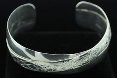 "One Renee Lupre ((c) ca. 1980), Sterling Silver, Floral Cuff Bracelet. The bracelet measures 13.2mm in the middle of the bracelet and 18.5mm+ at the ends. The bracelet measures 6 1/8\" on the exterior with a 1\" gap. All the appropriate hallmarks are present and total weight is 36.80 grams. Most items purchased before 2pm EST will be shipped same day using USPS First Class Mail (\"2-3day\") and will be insured, requiring signature upon delivery. In the event that key employees are on a buying t Formal Adjustable Stamped Bangle, Formal Adjustable Etched Cuff Bracelet, Adjustable Hallmarked Cuff Bracelet For Anniversary, Floral Cuff Bracelet, Floral Cuff, Gold Diamond Band, Jewelry Business, Atlanta Ga, Quality Diamonds