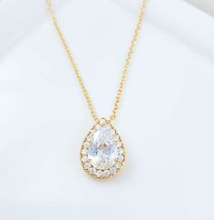 "This cubic zirconia teardrop necklace is made with a 13x16mm teardrop pendant which hangs on an adjustable cable chain with a lobster clasp, which can be worn from 18 to 19-1/2 inches. This sparkly necklace is perfect for weddings, proms or any pretty occasion. Thank you for looking.   NOTE: Gemsicles' gold-filled, rose/gold-plated, antiqued, silver and rhodium jewelry is cadmium-free, lead-free and nickel-free. Also, our plated jewelry is dipped in a special coating to help prevent fading. :) Teardrop Brilliant Cut Necklace For Wedding, Teardrop Brilliant Cut Wedding Necklaces, Wedding Teardrop Necklace With Brilliant Cut, Gold Cubic Zirconia Drop Necklace, Classic Teardrop Solitaire Necklace For Wedding, Gold Cubic Zirconia Teardrop Bridal Necklace, Brilliant Cut Cubic Zirconia Teardrop Pendant Necklace, Cubic Zirconia Teardrop Pendant With Brilliant Cut, Brilliant Cut Teardrop Cubic Zirconia Drop Necklace