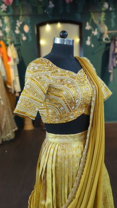 Silk pattu pavada set in beautiful deep gold. Pearl embroidery blouse and matching gold dupatta. Size: Please choose a standard size from the drop-down or your can choose custom measurements. if you choose custom measurements, I'll send you a measurements chart which you can fill out. please contact me for any customisation or if you need this in other colours. Gold Pre-draped Saree With Intricate Embroidery For Reception, Gold Embroidered Silk Pre-draped Saree, Gold Pre-draped Saree With Dori Work, Gold Silk Lehenga For Wedding, Gold Embroidered Art Silk Pre-draped Saree, Yellow Dola Silk Pre-draped Saree For Reception, Gold Lehenga In Raw Silk With Resham Embroidery, Gold Silk Choli With Resham Embroidery, Gold Kundan Blouse Piece With Dori Work