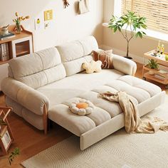 a living room filled with furniture and a white rug on top of a hard wood floor