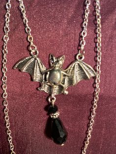 Bat and black gem necklace silver effect Silver Vampire Style Necklace, Black Metal Pendant Jewelry, Black Gothic Metal Necklace, Black Vampire Pendant Jewelry, Nickel-free Halloween Party Necklace, Gothic Sterling Silver Chain Necklace, Black Vampire Style Pendant Jewelry, Black Pendant Necklace For Formal Occasions, Gothic Dangle Necklaces For Parties