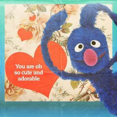 a blue stuffed animal holding a red heart with the words you are oh so cute and adorable