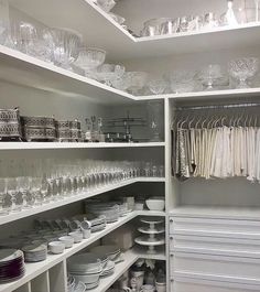 the shelves are filled with dishes and glasses