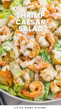 shrimp caesar salad with lettuce and tomatoes in a white bowl