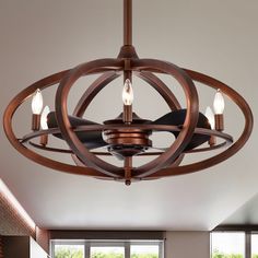 a light fixture in a room with large windows and wood accents on the ceiling,