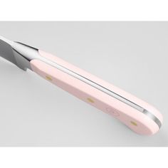 a pink and silver electric toothbrush on a white background