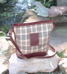 Baker Elizabeth Bag Elegant purse from the Baker Luggage Collection. Fully lined with shoulder strap, interior pockets, embossed leather Baker emblem, and leather bottom. Item Specifications: Colors: Baker Plaid with Black Trim Baker Plaid with Brown Trim Size: 11 1/2" wide x 12" tall x 57" Material: 100% Acrylic with Leather Trim Horse Purse, Brown Trim, Healing Herbs, Equestrian Style, Women's Handbags, Nice Things, Fresh Herbs, Fresh Food, Plaid Pattern