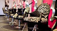 zebra print chairs are lined up against the wall