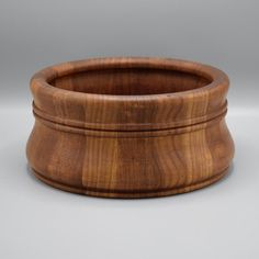 a wooden bowl sitting on top of a table