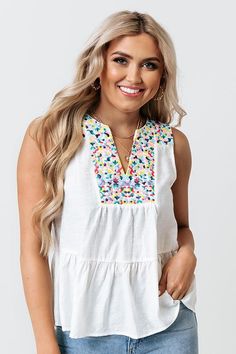 Liven up your wardrobe with our adorable white 'Tahitian Gardens' top featuring lightweight material with colorful embroidered detailing across the bodice and shoulders, a sleeveless fit with a v-notch neckline, and a relaxed silhouette that falls into a peplum bottom with an uneven hemline! Embroidered Hem Top For Summer Vacation, White Floral Embroidered Sleeveless Top, White Sleeveless Top With Floral Embroidery, White Sleeveless Embroidered Top For Beach, White Sleeveless Embroidered Top, Spring Tops With Multicolor Embroidery And Embroidered Neckline, Multicolor Geometric Embroidered Top For Spring, Multicolor Geometric Embroidery Top For Spring, Sleeveless Multicolor Embroidered Top For Vacation