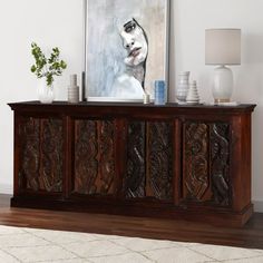 an ornate wooden sideboard in a living room