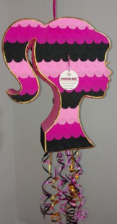 a pink and black paper sculpture hanging from the ceiling