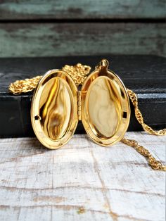 This is a vintage 1960s double chain locket necklace, marked Park Lane on a metal tag. It is a gold tone metal. There is one short chain and one long chain. The shortest chain is 16 in., and the longest chain is 24 in. long. The oval locket is 1 3/4 in. long, and 1 1/8 in. wide, without the bail. The necklace is in great condition. Thank you for looking! Vintage Gold Medallion Necklace With Chain, Vintage Gold Chain Medallion Necklace, Retro Gold Jewelry With Adjustable Chain, Vintage Gold Chain Necklace With Medallion, Vintage Medallion Gold Chain Necklace, Antique Gold Metal Locket Necklace, Gold Metal Locket Necklace With Vintage Charm, Gold Brass Locket Chain Necklace, Retro Gold Necklace With Adjustable Chain