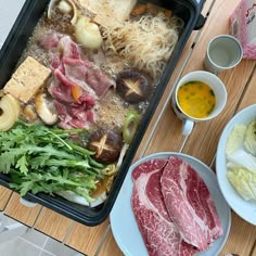 an assortment of meats and vegetables on a table