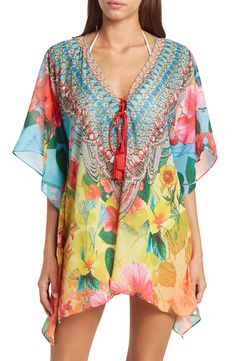 A breezy and lightweight poncho in a blooming floral print brings effortless boho vibes to your wardrobe. 31'' length (O/S) V-neck with lace-up closure Kimono sleeves All-over print Woven 100% polyester Dry clean Imported Model stats: 5'10", 32" bust, 25" waist, 36" hip. Model is wearing size OS. Bohemian V-neck Kaftan For Spring, Bohemian V-neck Cover-up With Floral Print, Bohemian V-neck Floral Print Cover-up, Spring Floral Print V-neck Kaftan, V-neck Floral Print Festival Cover-up, Printed Tunic Cover-up For Spring, Multicolor Boho Print Kaftan For Spring, Spring Multicolor Boho Print Kaftan, Spring Vacation V-neck Poncho