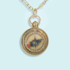 Tiny brass compass on gold long and short link chain. Metal: Brass compass, 14kt gold filled chain Size: .5" W compass, 18" chain Lobster clasp Brass Compass, Red Flower Necklace, Compass Jewelry, Book Vibes, Pink Sapphire Pendant, Honeycomb Necklace, Widget Icons, Jewelry Piercing, Compass Design